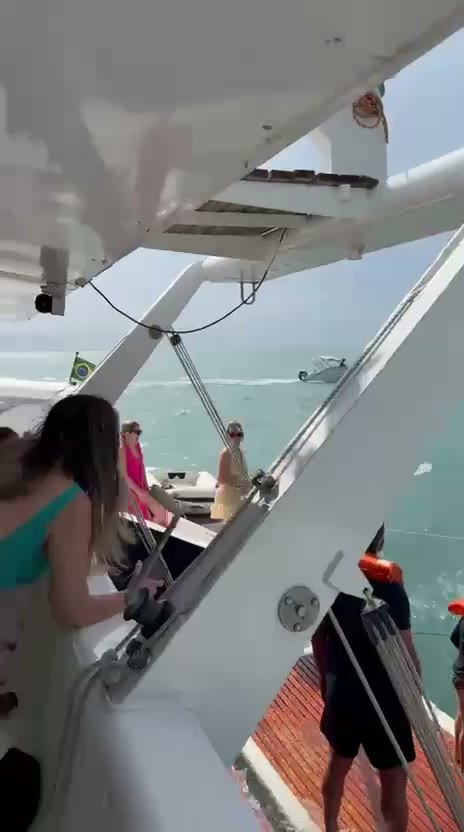 Video: grupo animado a bordo do catamara em movimento pela costa de Ilhabela